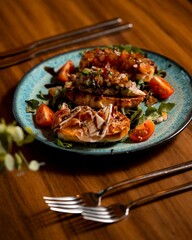 Gourmet bruschetta on a blue plate.