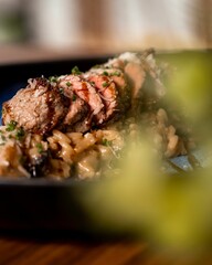 Gourmet steak and pasta dish close-up.