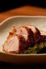 Of crispy breaded pork slices on a bed of sauteed greens