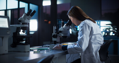 Medical Research and Development Laboratory: Hard-Working Asian Female Scientist Using Computer and...