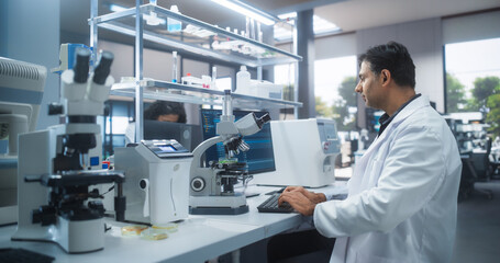 Molecular Biology Research Scientist Looking at a DNA Sample Under a Microscope in an Applied...