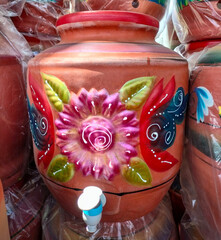 A pot made of soil called matka.Matka cools the water naturally and used in every house hold Eco-friendly Earthen clay drinking water pot. Clay water jug pot with handle, lid and tap keeps water cool.