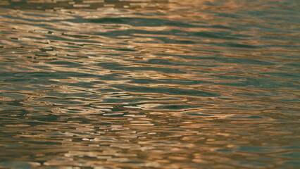 Soft Waves Ripples At Hour In Evening. Water Is Filled With Light. Liquid With Shimmer.