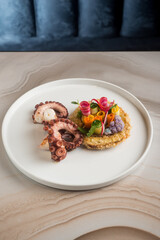 grilled octopus on fried breaded aubergine and vegetable salad