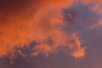 Moody storm clouds illuminated by vibrant sunset light—an inspiring backdrop for artistic or commercial use