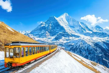 Handdoek met foto Yellow train traversing snowy alps landscape with majestic mountain view. © SerPak