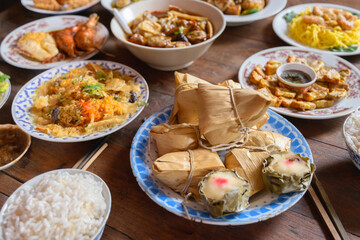 Fake foods made by hand, traditional meals with various kinds of Chinese foods, food replicas, focus at Zongzi, Chinese sticky rice dumpling