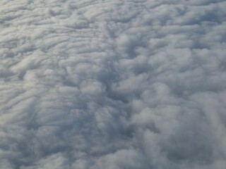 Airplane flying over white clouds background