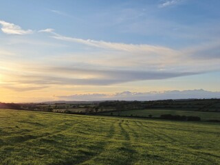 Cloudy Sky Over Agricultural Landscape with Grass and Cumulus Forms