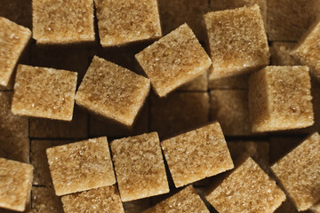 Cubes of brown cane unrefined demerara sugar.