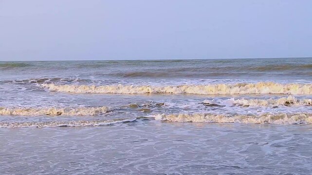 An enchanting view of the waves rolling onto Cox's Bazar sea beach, showcasing the dynamic beauty of the world's longest sandy beach.