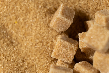Brown cane unrefined demerara sugar in the form of crystals and cubes