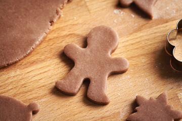 Man shape cut out from pastry dough - preparation of homemade gingerbread Christmas cookies