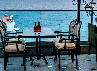 Table and chairs on the veranda of a summer cafe near the sea.