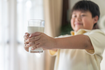 Asian boy drinking milk for healthy growth in protein and calcium, promoting strong bones natural nutrition development, wellness vitality dairy beverage, happy childhood lifestyle, family care fresh