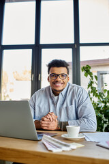 A cheerful man engages in his work from a bright home office, radiating positivity and focus.