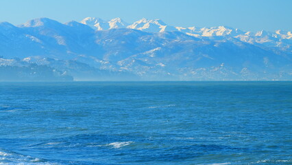 Morning Over Sea Landscape. Dramatic Distant Mountains And Shore. Real time.