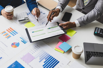 Businessman meeting with financial advisors analyzing market share and sales situation to solve problems and plan business strategies.