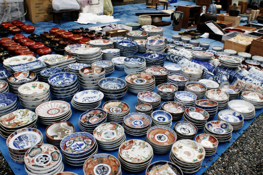 Japanese porcelain dishes on sale at the famout Kobo Market in Kyoto. Imari ware produced in the town of Arita at the Kyushu Island, colorful, decorative ceramic plates and urushi lacquerware.