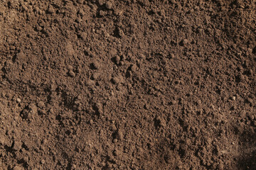 Brown dark soil ground abstract texture background with copyspace top view