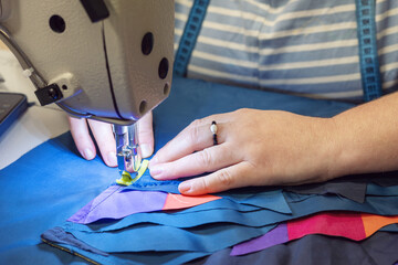 The process of sewing clothes from the remains of textiles and cut clothes. Upcycling, recycling, conscious consumption, zero waste. Youth clothing brand, sustainable fashion, reuse of materials.