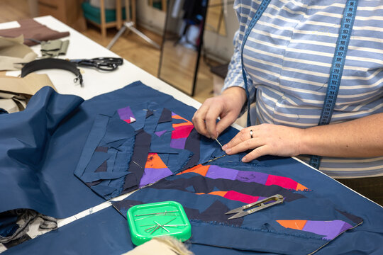 The process of sewing clothes from the remains of textiles and cut clothes. Upcycling, recycling, conscious consumption, zero waste. Youth clothing brand, sustainable fashion, reuse of materials.