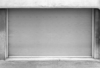 Closed steel shutter door of warehouse, storage or storefront for metal door background and textured