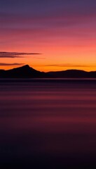 Fototapeta premium view of a sunset over a body of water