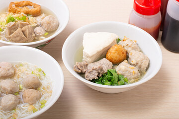 Bakso sapi, Various beef meatballs with accompaniments on wooden table. Most popular Indonesian foods
