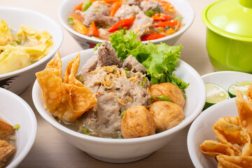 Bakso sapi, Various beef meatballs with accompaniments on wooden table. Most popular Indonesian foods