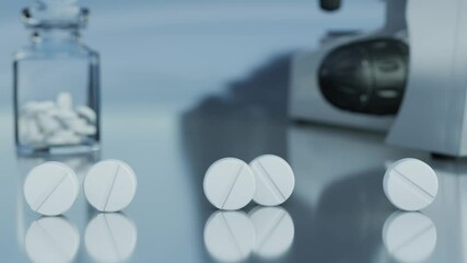 White tablets are rolling across a pharmacist's desk. In the background, a microscope, additional pills, and a glass container filled with pills can be seen. 3d rendering