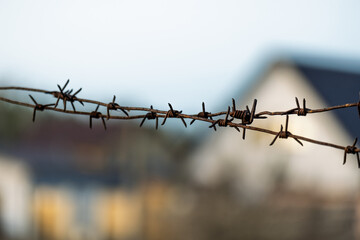The roof of the building is out of focus, with barbed wire in the foreground