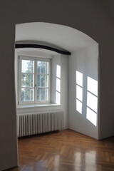 Empty interior of a old house with reflections of sunlight through the window with blinds