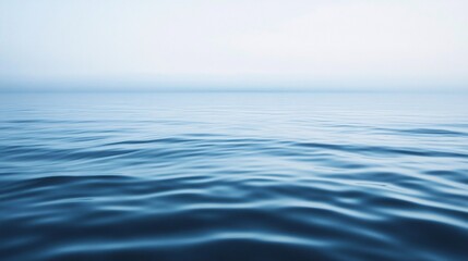 Naklejka premium Calm ocean water surface reflecting sky at dusk with minimalistic composition