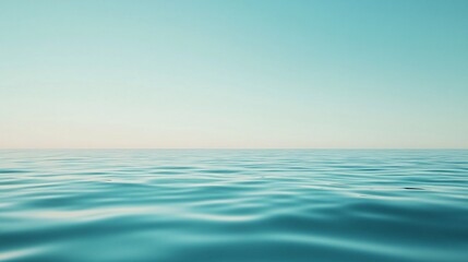 Obraz premium Calm turquoise ocean reflecting pastel sky at sunrise