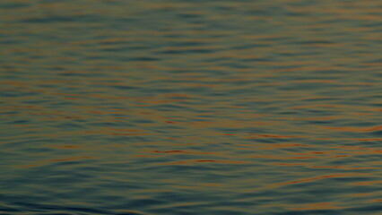 Gorgeous Contrast Between Warm Shades Of Sunset. Golden Colored Calm Sea Water At Sunset. Slow motion.