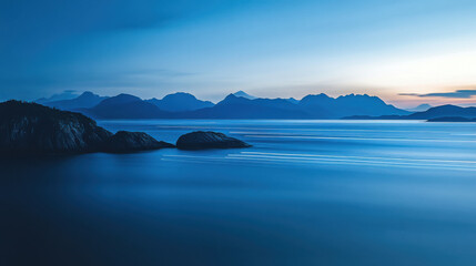 Fototapeta premium serene landscape at dusk with tranquil water and distant mountains