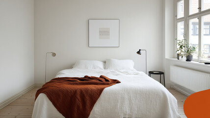 Obraz premium A cozy bedroom featuring large bed with white linens and warm brown throw blanket. minimalist decor includes stylish lamps and small plant, creating serene atmosphere
