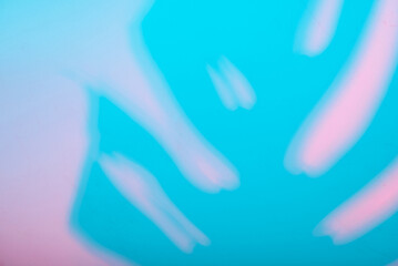 Blurred hands on vibrant blue and pink background
