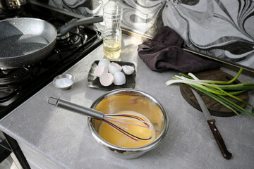 Cooking an omelet for breakfast in the home kitchen at home.