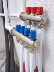 New manifold for underfloor heating with manual handles for opening manifold valves. Installing...