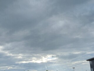 Cloudy Sky Over Grassland and City Landscape