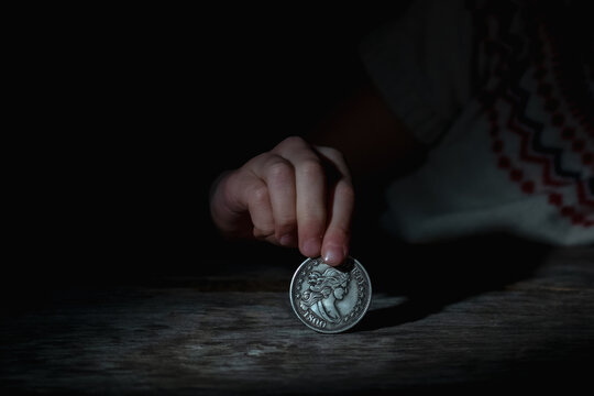Crown of thorns and rosary beads on brown texture background with space for text