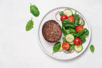 Grilled marbled beef with spinach salad on a plate on a white background with copy space. Protein lunch, healthy eating