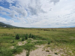 Cloudy Sky Over Grassy Plain Landscape