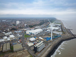 Aerial view of the costal town of Lowestoft, Suffolk, UK. Showing the North Sea defences and wind turbine seen in the industrial area of the city.