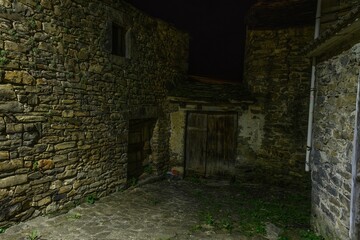 Fototapeta premium Charming stone alley at night with bright lights in Torla - Huesca