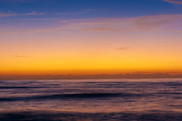 Serene Ocean View With Vibrant Sunset And Gentle Waves