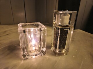 Candle and pepper on a restaurant table background