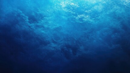 Calm deep blue ocean water with light reflections creating an ethereal atmosphere.
